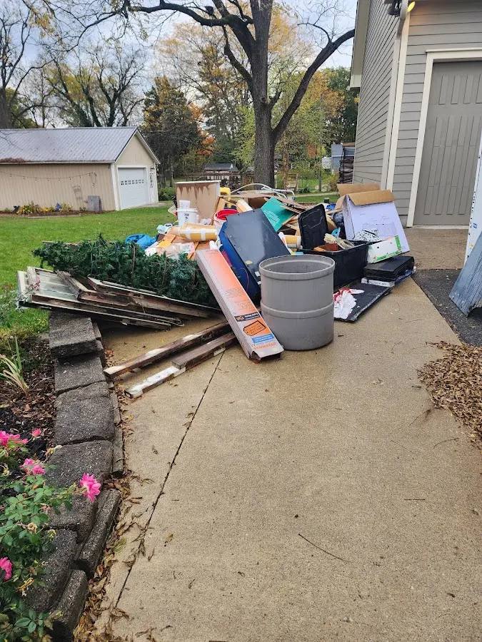 Dumpster being loaded with debris for Estate Cleanout Dumpster Rental in Greenville
